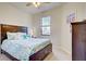Bedroom with a dark wood bed frame and teal bedding at 20272 Tesoro Dr, Venice, FL 34293
