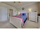 Well-lit bedroom featuring a white bed frame and blue bedding at 20272 Tesoro Dr, Venice, FL 34293