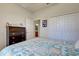 Bedroom with a dark wood dresser and teal bedding at 20272 Tesoro Dr, Venice, FL 34293