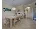 Bright dining room with a large table and six chairs, adjacent to a hallway at 20272 Tesoro Dr, Venice, FL 34293