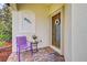 Welcoming front entry with purple chair and potted plants at 20272 Tesoro Dr, Venice, FL 34293