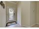 Bright and airy foyer with decorative door and nautical rug at 20272 Tesoro Dr, Venice, FL 34293