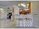 Kitchen with breakfast bar, light wood cabinets, and granite countertops at 20272 Tesoro Dr, Venice, FL 34293