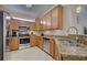Modern kitchen with stainless steel appliances and granite countertops at 20272 Tesoro Dr, Venice, FL 34293