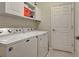 Laundry room with washer, dryer, and storage cabinets at 20272 Tesoro Dr, Venice, FL 34293