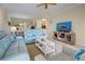 Bright living room with light blue reclining sofas, coffee table, and large TV at 20272 Tesoro Dr, Venice, FL 34293