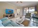 Comfortable living room with light blue sofas and flat-screen TV at 20272 Tesoro Dr, Venice, FL 34293