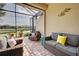 Screened patio with comfortable seating and pond view at 20272 Tesoro Dr, Venice, FL 34293