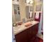 Double vanity bathroom with updated cabinets and a large mirror at 223 Roma Rd, Venice, FL 34285