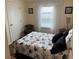 Bright bedroom with a floral comforter and wooden furniture at 223 Roma Rd, Venice, FL 34285