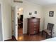 Bedroom with dresser and view into living room at 223 Roma Rd, Venice, FL 34285