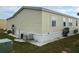 Side view of mobile home with AC unit at 223 Roma Rd, Venice, FL 34285