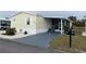 Mobile home with paved driveway and mailbox at 223 Roma Rd, Venice, FL 34285