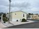 Front view of a yellow mobile home at 223 Roma Rd, Venice, FL 34285