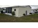 Side view of mobile home with landscaping at 223 Roma Rd, Venice, FL 34285
