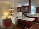 Kitchen with dark wood cabinets and a breakfast bar at 223 Roma Rd, Venice, FL 34285