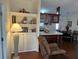Open concept kitchen and dining area with dark wood cabinets and breakfast bar at 223 Roma Rd, Venice, FL 34285