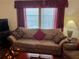 Living room boasts a comfy sofa and red accent pillows at 223 Roma Rd, Venice, FL 34285