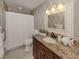 Updated bathroom with granite countertop and decorative wallpaper at 2269 Lakewood Dr, Nokomis, FL 34275