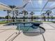 Relaxing pool and spa with lake views and screened enclosure at 2269 Lakewood Dr, Nokomis, FL 34275