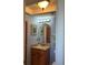 Clean bathroom with wood vanity and light blue walls at 232 Saint Augustine Ave # 404, Venice, FL 34285