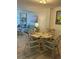 Small dining area with glass top table and four chairs at 232 Saint Augustine Ave # 404, Venice, FL 34285