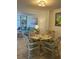 Dining area with four chairs and a glass-top table at 232 Saint Augustine Ave # 404, Venice, FL 34285