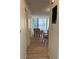 Hallway with wood-look floors offering a view of living room with comfy chairs at 232 Saint Augustine Ave # 404, Venice, FL 34285