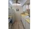 Full view of kitchen with white cabinets, yellow countertops, and a ceiling fan at 232 Saint Augustine Ave # 404, Venice, FL 34285