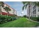 Landscaped grounds with lush greenery between two apartment buildings at 232 Saint Augustine Ave # 404, Venice, FL 34285