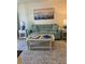 Living room with teal sofa, coffee table, and patterned rug at 232 Saint Augustine Ave # 404, Venice, FL 34285