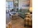 Living area featuring a sofa, chairs, and balcony view at 232 Saint Augustine Ave # 404, Venice, FL 34285