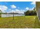 Large backyard with a white fence and grassy area at 3328 Waterloo Ter, North Port, FL 34286