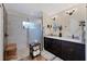 Elegant bathroom with double vanity, walk-in shower, and pebble floor at 3328 Waterloo Ter, North Port, FL 34286