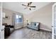 Bright bonus room features wood-look floors, comfy seating, and a ceiling fan at 3328 Waterloo Ter, North Port, FL 34286