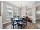 Bright dining room with round table and hardwood floors at 3328 Waterloo Ter, North Port, FL 34286
