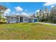 Single-story home with teal garage door and lush lawn at 3328 Waterloo Ter, North Port, FL 34286