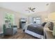 Spacious main bedroom with large bed, TV, and sliding glass doors to backyard at 3328 Waterloo Ter, North Port, FL 34286