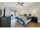 Main bedroom with king bed, backyard access, and ceiling fan at 3328 Waterloo Ter, North Port, FL 34286