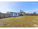 Fenced backyard with lawn and a view of the house at 370 Waltham St, Port Charlotte, FL 33952