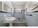 Bathroom with light blue tiled walls and pedestal sink at 370 Waltham St, Port Charlotte, FL 33952