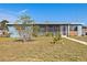 Blue ranch home with a screened porch at 370 Waltham St, Port Charlotte, FL 33952