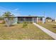 Ranch style home with screened porch and landscaped lawn at 370 Waltham St, Port Charlotte, FL 33952