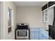 Bright kitchen features stainless steel appliances and light blue cabinets at 370 Waltham St, Port Charlotte, FL 33952