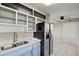 Kitchen with stainless steel refrigerator and light blue cabinets at 370 Waltham St, Port Charlotte, FL 33952