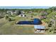 Aerial view of property with pond and outbuildings at 3740 Hidden Valley Cir, Punta Gorda, FL 33982