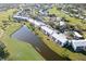 Aerial view of community near golf course and water at 404 Cerromar N Cir # 116, Venice, FL 34293