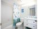 Updated bathroom with white vanity, shower/tub combo, and nautical-themed decor at 404 Cerromar N Cir # 116, Venice, FL 34293