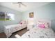 Bedroom with twin beds, nightstand, and ceiling fan at 404 Cerromar N Cir # 116, Venice, FL 34293