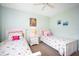 Bedroom with twin beds, nightstand, and ceiling fan at 404 Cerromar N Cir # 116, Venice, FL 34293